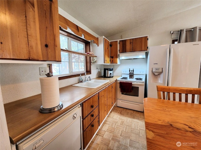 kitchen with lofted ceiling, sink, a textured ceiling, white appliances, and light parquet floors