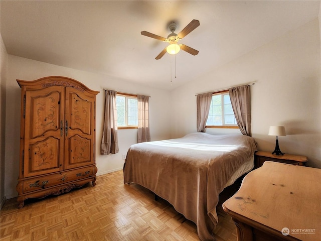 bedroom featuring ceiling fan, lofted ceiling, multiple windows, and light parquet floors