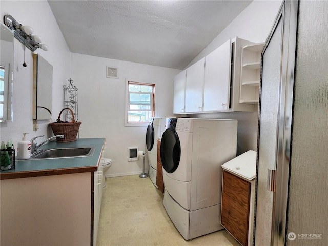 washroom with separate washer and dryer, sink, and heating unit