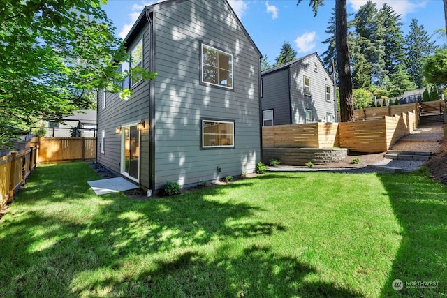 rear view of house featuring a yard