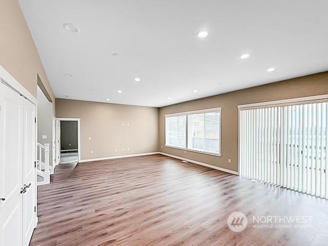 unfurnished living room featuring wood-type flooring