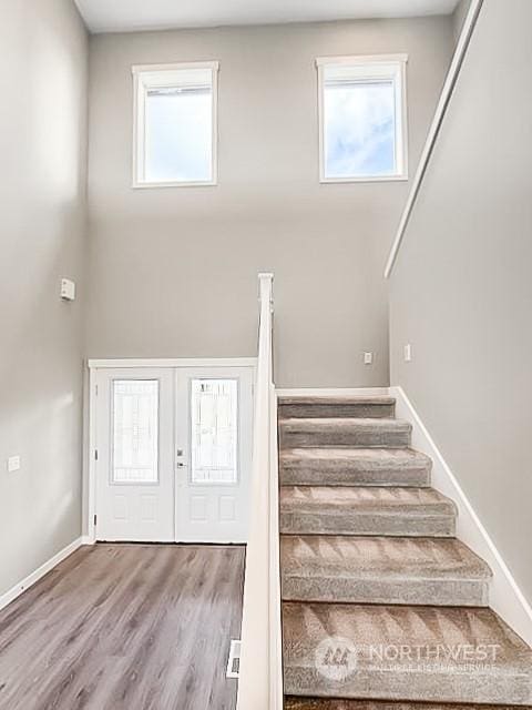 stairs featuring wood-type flooring