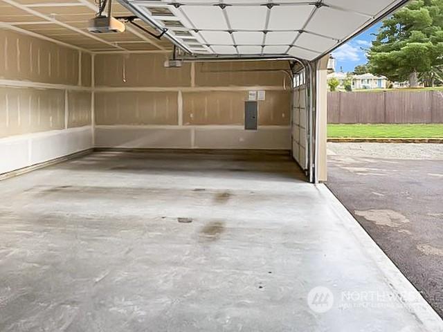 garage featuring a garage door opener and electric panel