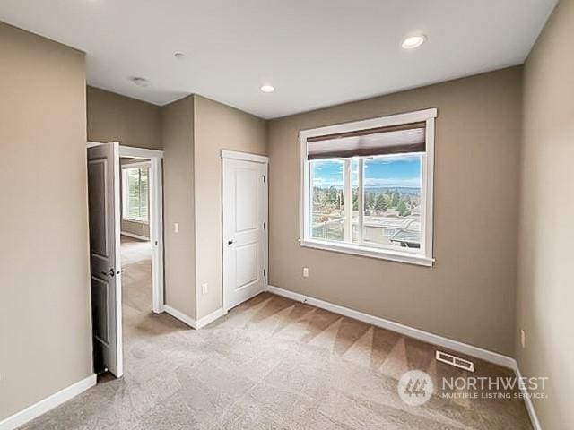 unfurnished bedroom featuring light colored carpet