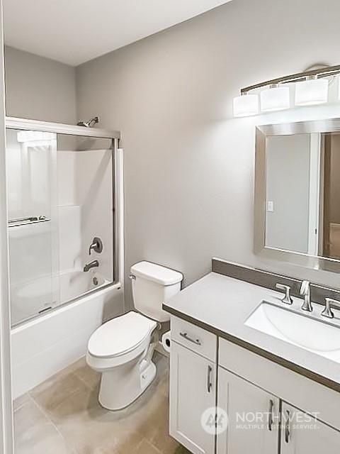 full bathroom featuring vanity, shower / bath combination with glass door, and toilet