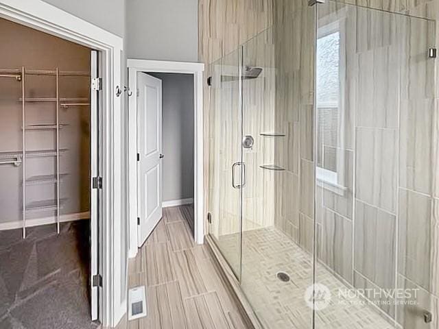 bathroom featuring an enclosed shower