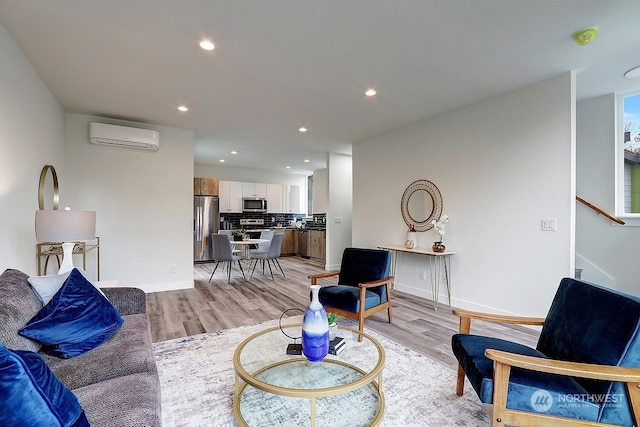 living room featuring light hardwood / wood-style flooring and an AC wall unit