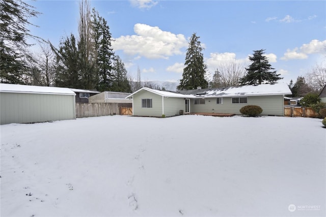 view of snow covered rear of property