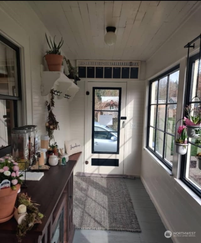 doorway to outside with wooden ceiling