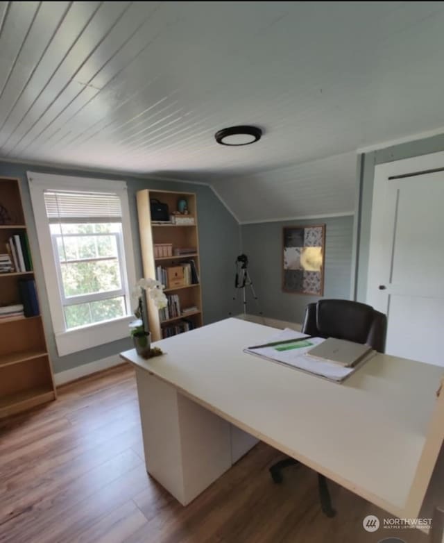 office space with wood-type flooring, vaulted ceiling, wooden ceiling, and built in shelves