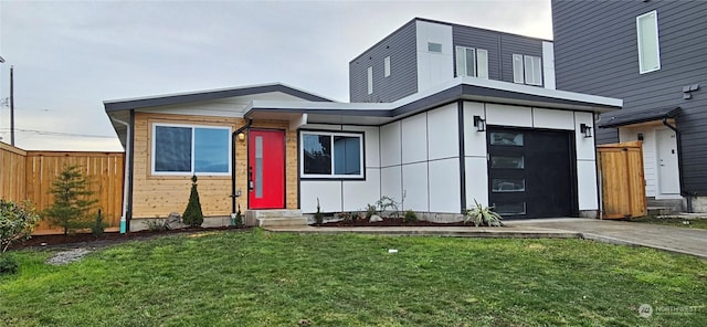 view of front of house featuring a front lawn and a garage