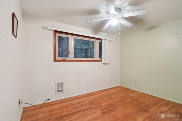 unfurnished room with ceiling fan and hardwood / wood-style floors