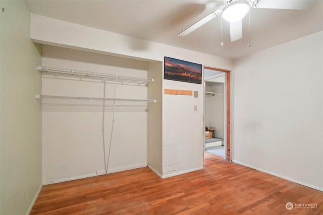 unfurnished bedroom featuring wood-type flooring and ceiling fan