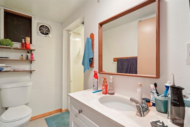 bathroom with vanity, tile patterned floors, and toilet