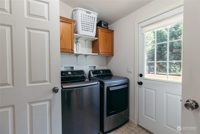 washroom featuring cabinets and washing machine and clothes dryer