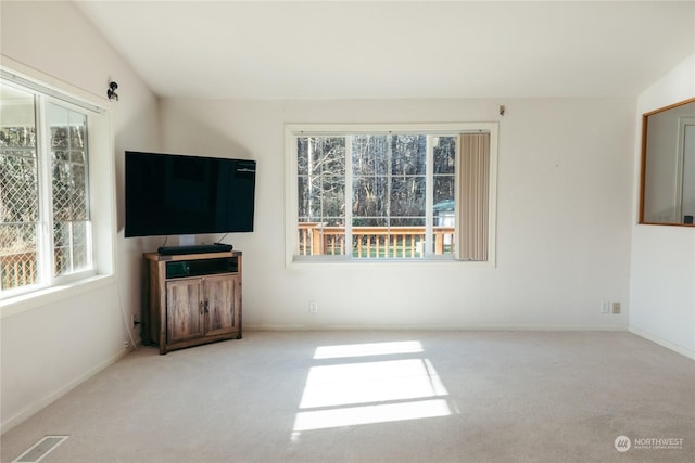 unfurnished living room featuring light carpet