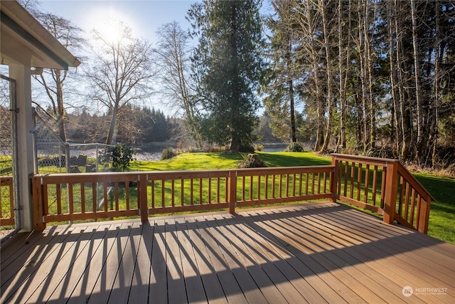 wooden terrace featuring a lawn