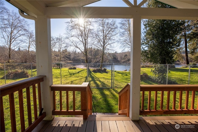 wooden deck featuring a yard and a water view