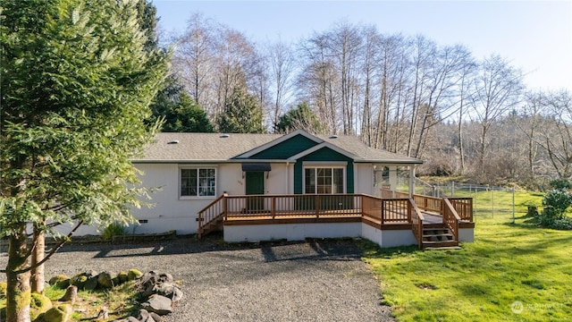 view of front of house with a wooden deck and a front yard