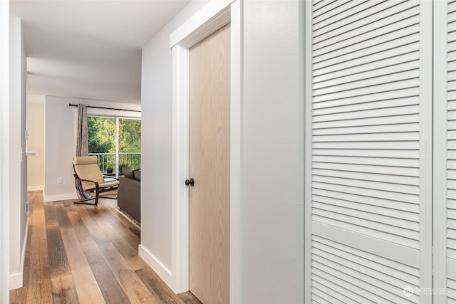 corridor with hardwood / wood-style flooring