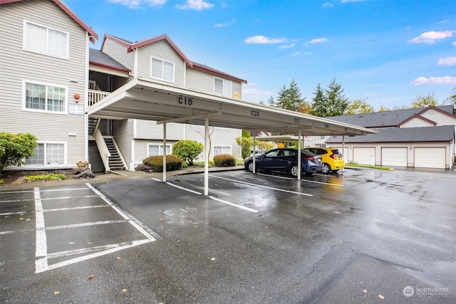 view of parking featuring a carport and a garage