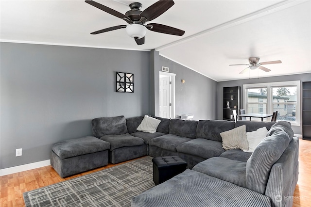 living room featuring vaulted ceiling, hardwood / wood-style floors, ceiling fan, and crown molding