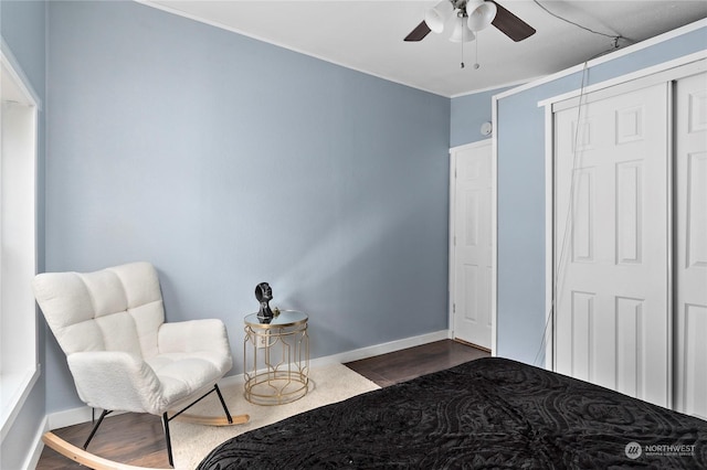 bedroom featuring hardwood / wood-style floors, ceiling fan, and a closet