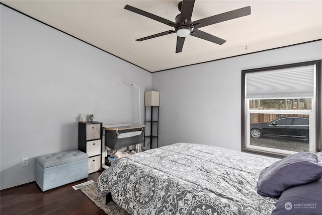 bedroom featuring dark hardwood / wood-style flooring and ceiling fan