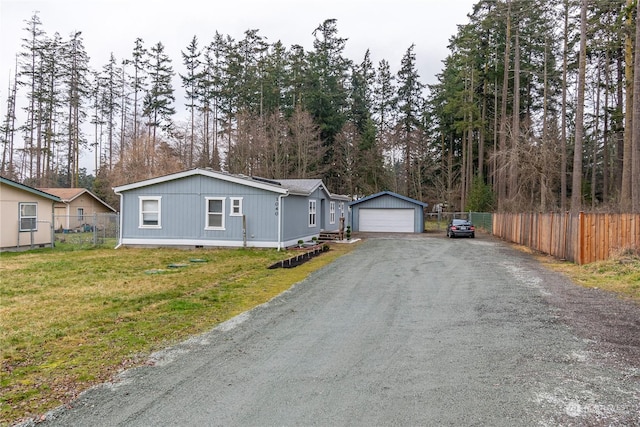 view of front facade with a garage, an outdoor structure, and a front yard