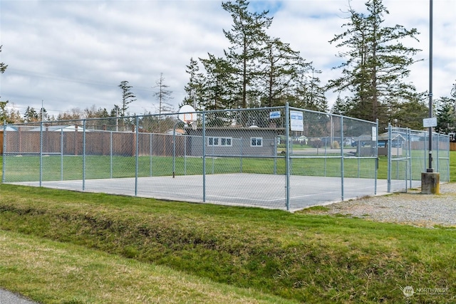 view of sport court featuring a yard