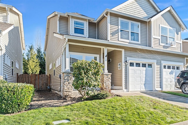 view of front of house with a garage, a porch, and a front yard