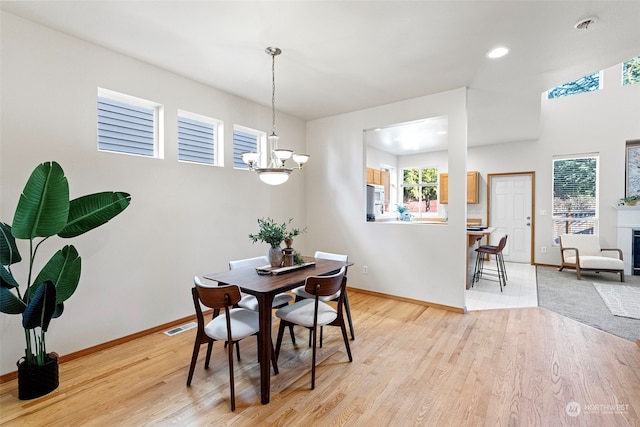 dining room with an inviting chandelier and light wood-type flooring