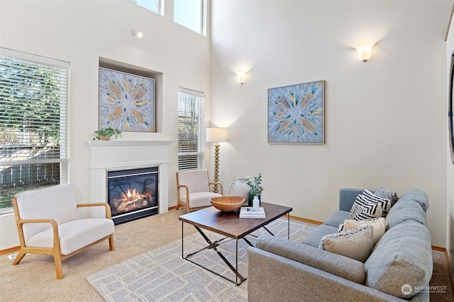 living room with light colored carpet and a towering ceiling