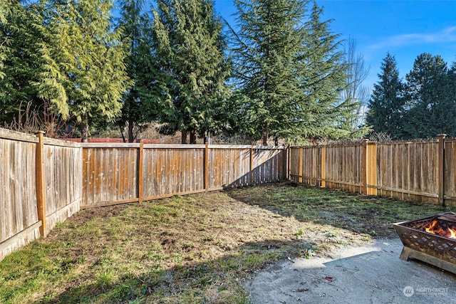 view of yard with an outdoor fire pit