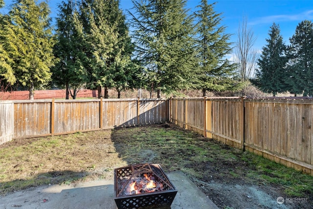 view of yard with a fire pit