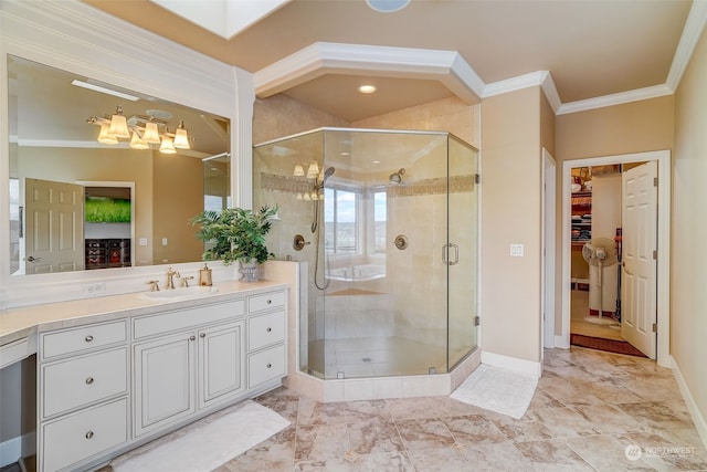 bathroom with vanity, baseboards, a spacious closet, a shower stall, and crown molding