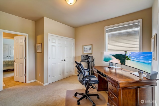 office with light carpet and baseboards