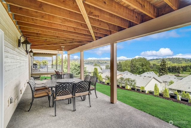 view of patio with a residential view and outdoor dining area