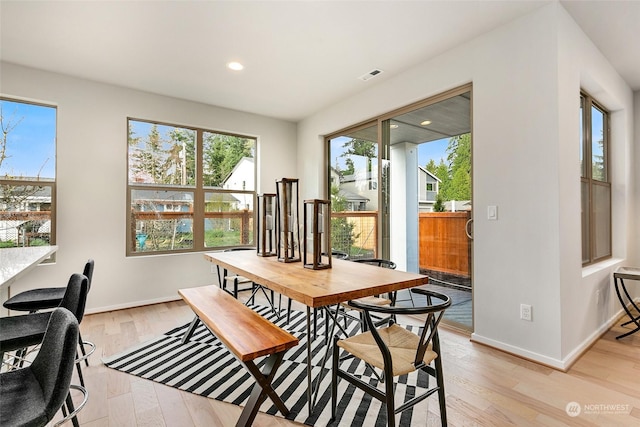 dining space with light hardwood / wood-style flooring