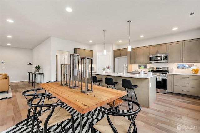 dining space featuring sink and light hardwood / wood-style floors