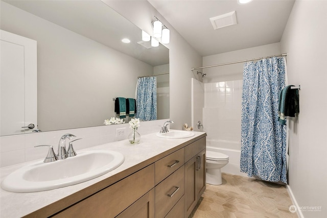 full bathroom featuring shower / tub combo with curtain, vanity, and toilet