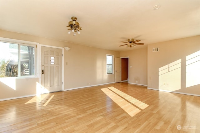 unfurnished living room with ceiling fan and light wood-type flooring