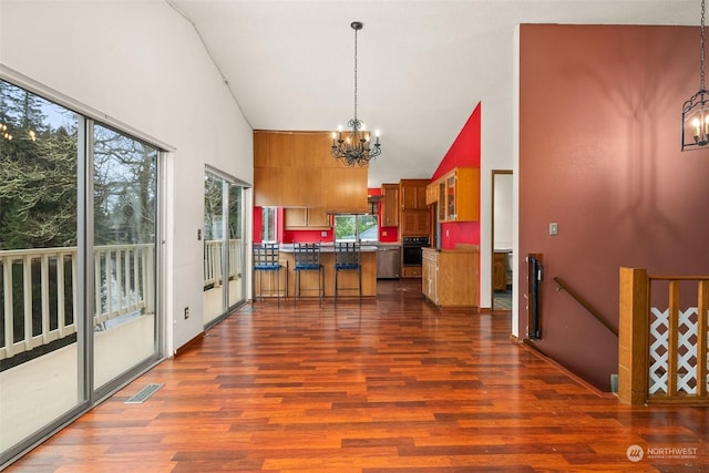 kitchen featuring a notable chandelier, dark hardwood / wood-style floors, oven, and hanging light fixtures