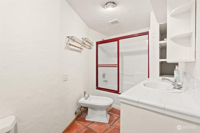 full bathroom with tile patterned floors, toilet, a textured ceiling, a bidet, and enclosed tub / shower combo