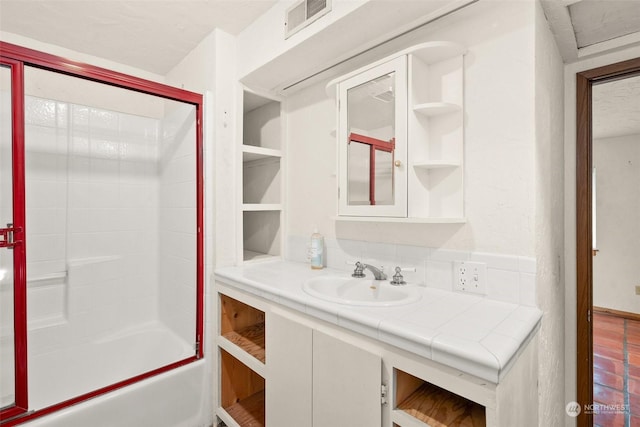 bathroom featuring  shower combination and vanity