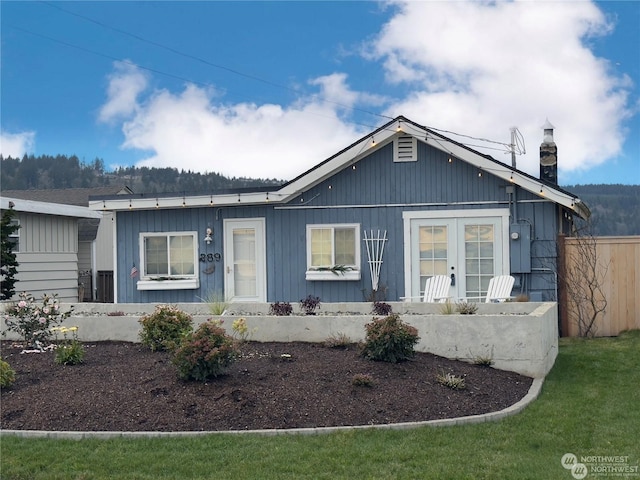 view of front of property with a front lawn and french doors