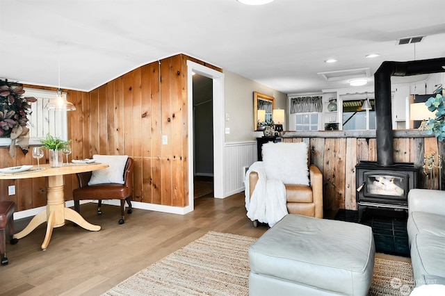 living room featuring wood-type flooring and a wood stove