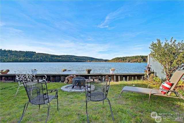 view of yard featuring a water view and a fire pit