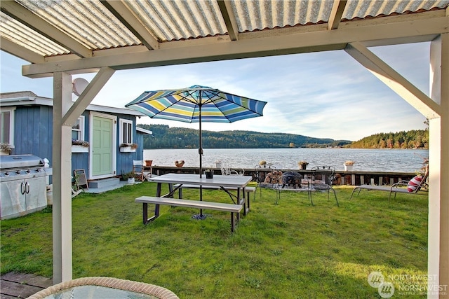 view of property's community featuring a water view and a yard