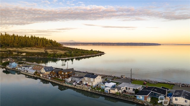 aerial view at dusk with a water view